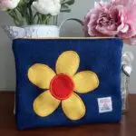 Makeup Bag - Navy blue Harris Tweed, with yellow and orange Harris Tweed flower appliqué